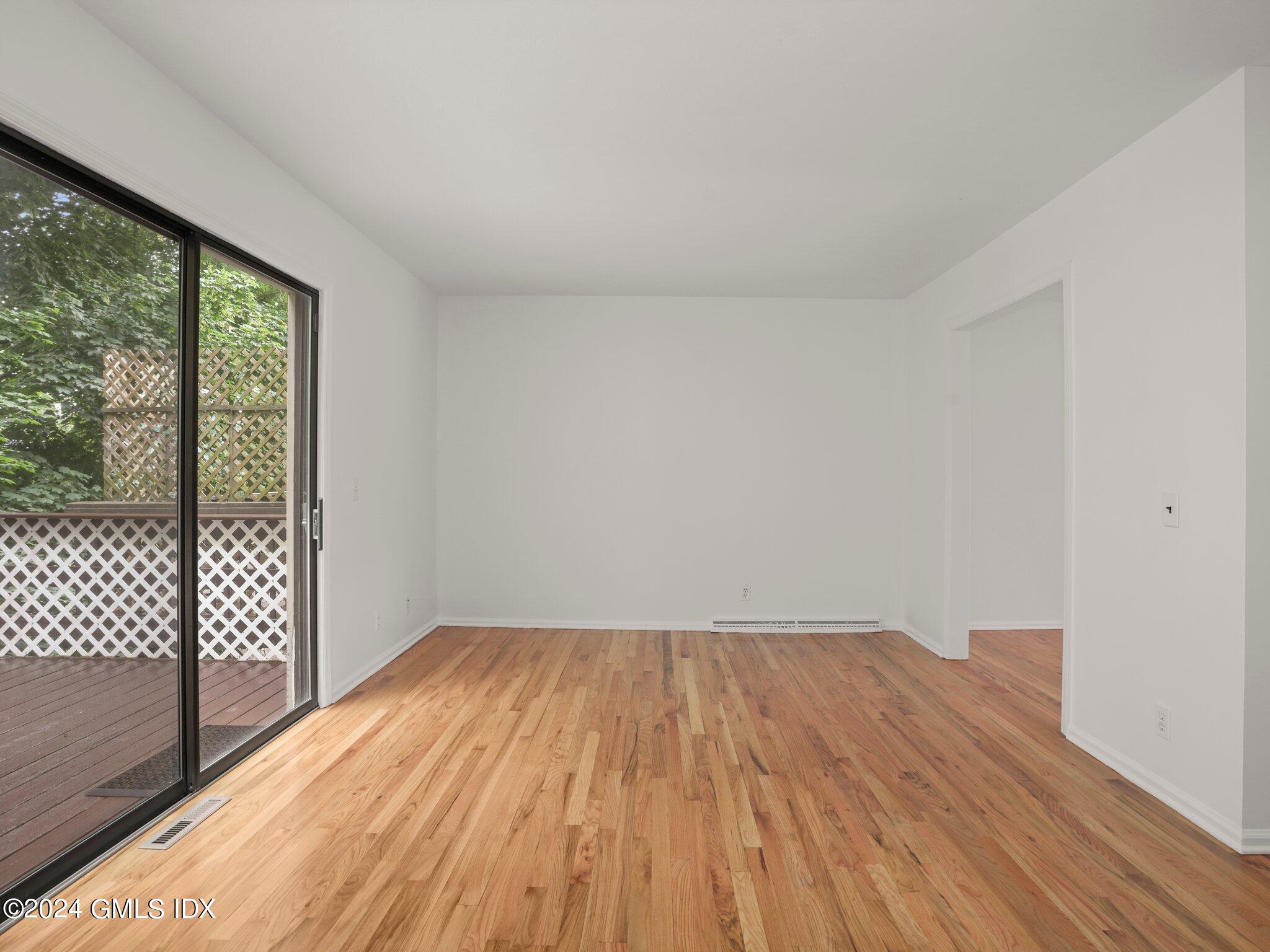413 Glenbrook Road, Unit 1 Stamford, CT 06906 - Photo 7 of 21 a view of wooden floor in a room