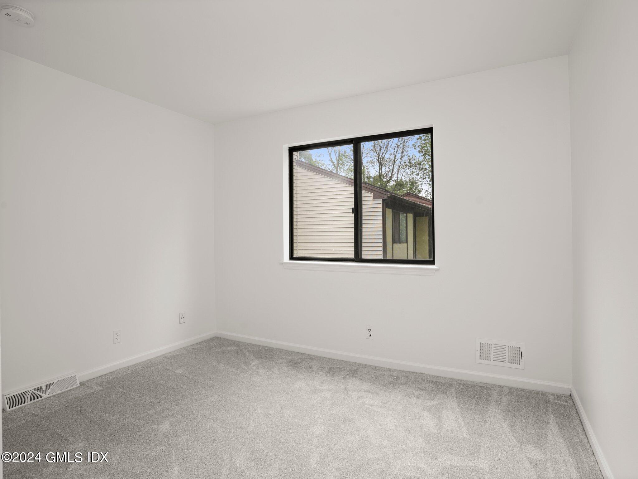 413 Glenbrook Road, Unit 1 Stamford, CT 06906 - Photo 9 of 21 an empty room with a window