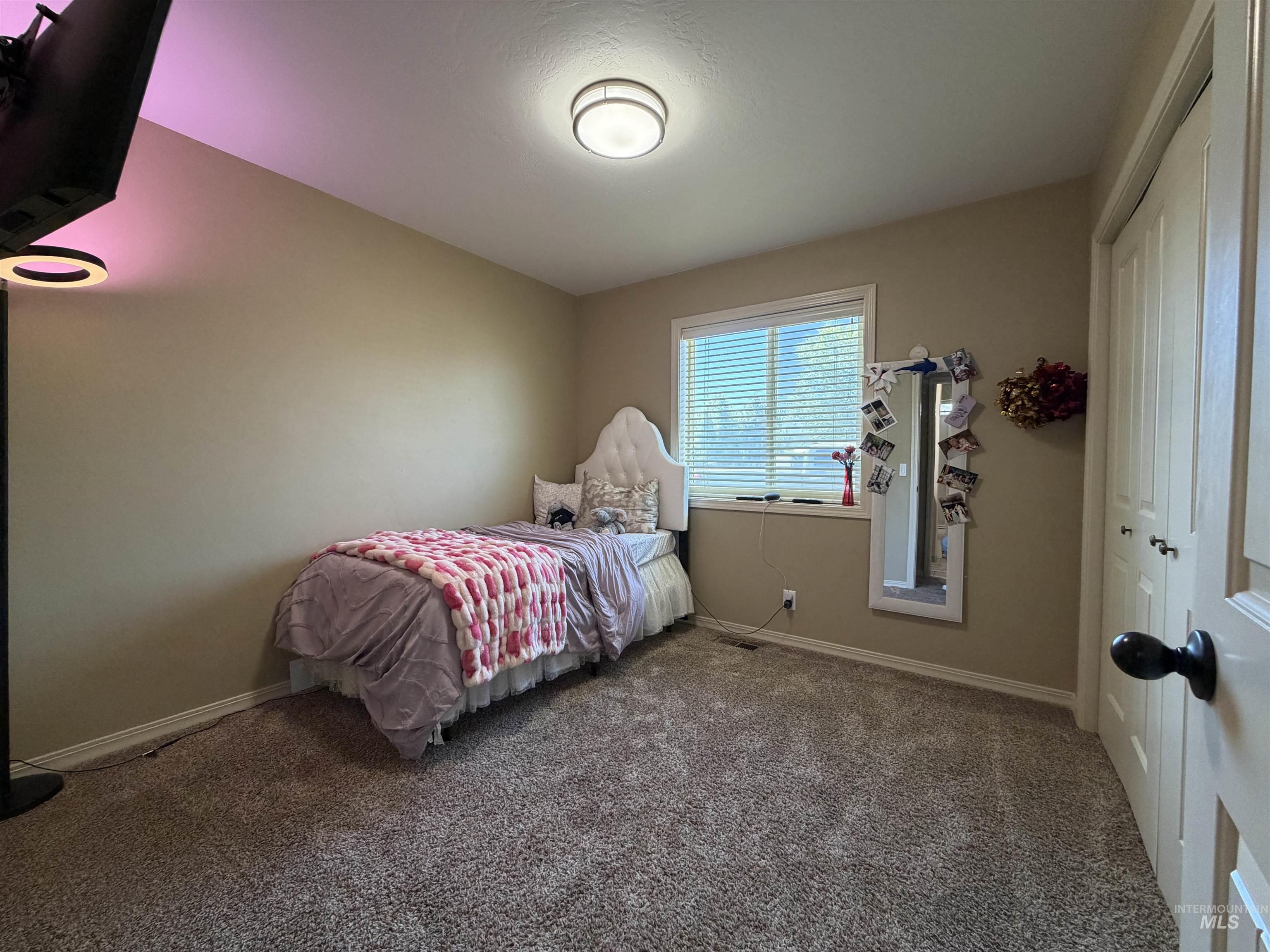 2000 M Street Heyburn, ID 83336 - Photo 8 of 15 Spacious room featuring neutral carpeting, a large window with blinds, and ample wall space