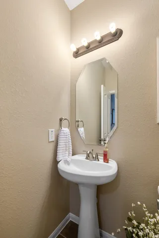 a bathroom with a sink a mirror and toilet