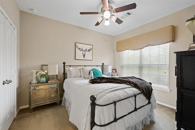 a bedroom with bed and a chandelier
