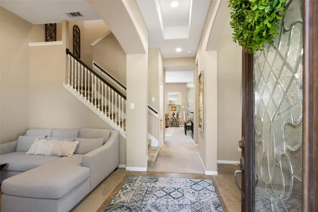 a living room with furniture and a potted plant