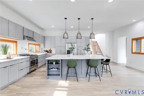 a large kitchen with a table and chairs in it