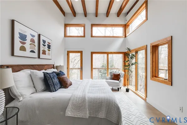 a bedroom with a large bed and a large window