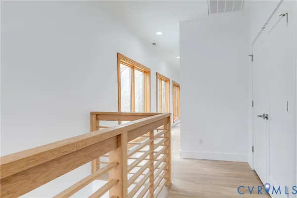 a bedroom with a bed and large windows