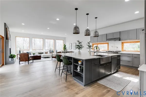 a kitchen with stainless steel appliances granite countertop a stove and a wooden floors