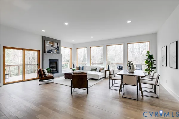 a living room with furniture and floor to ceiling windows