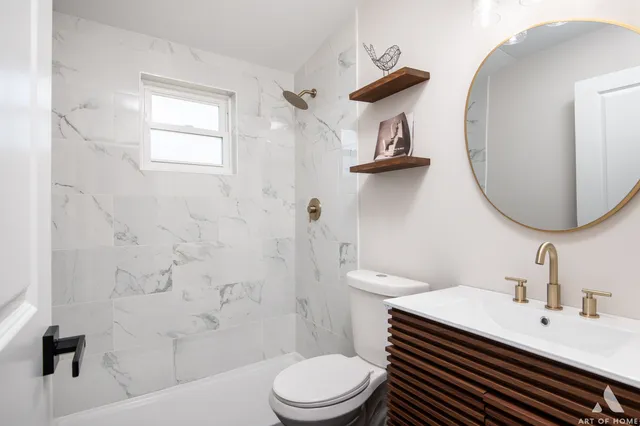 a bathroom with a sink a toilet and mirror