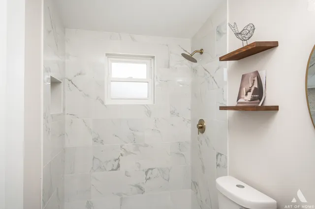 a bathroom with a toilet and a shower