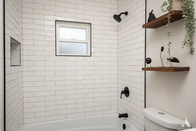 a bathroom with a bathtub and shower