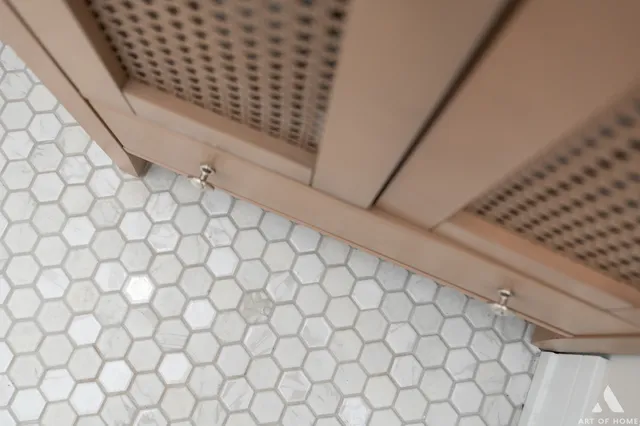 a bathroom with a white wall and a shower