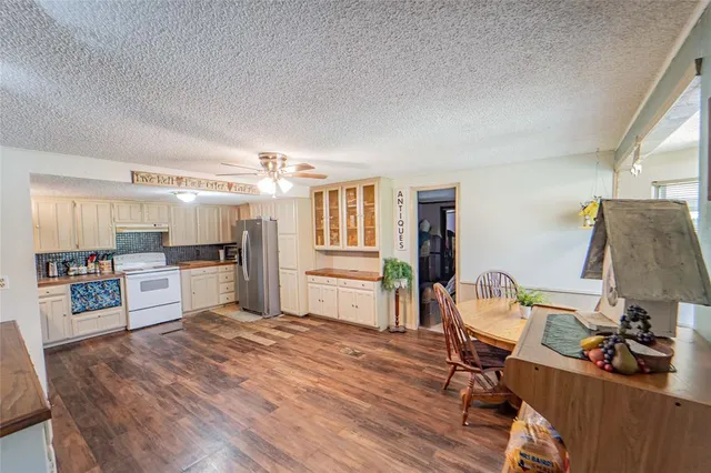 a bedroom with a large bed and a flat tv screen