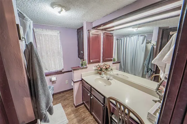 a living room with furniture a flat screen tv and a floor to ceiling window