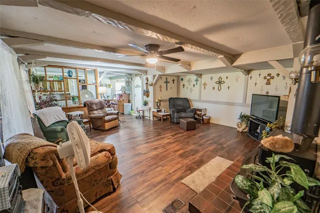 a living room with furniture a flat screen tv and a floor to ceiling window