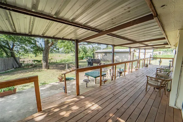a view of a balcony with wooden floor