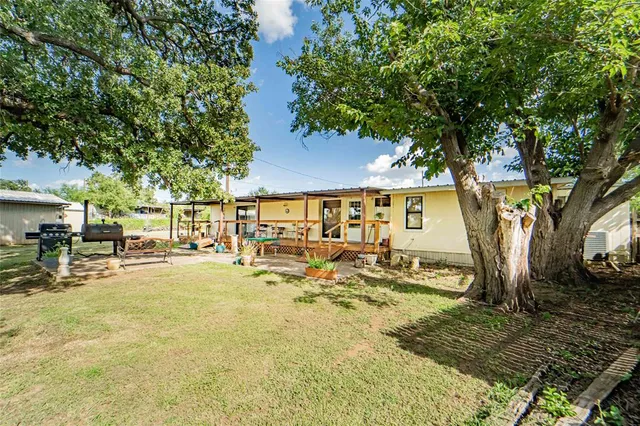 a view of backyard with seating area and trees