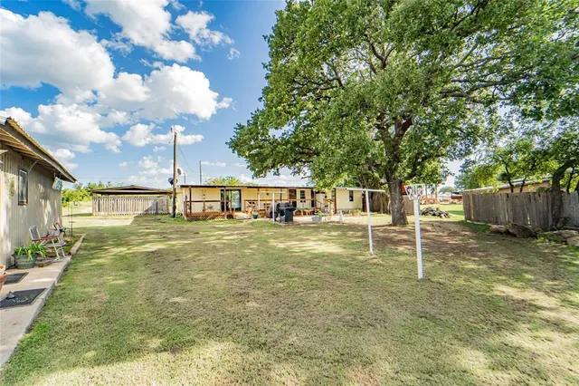 a view of a house with backyard porch and sitting area