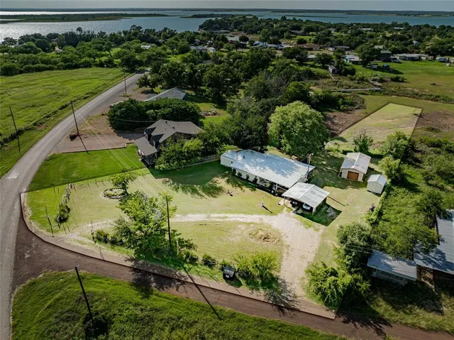 an aerial view of a house with a yard
