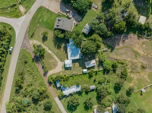 an aerial view of a house with a yard lake view and mountain view