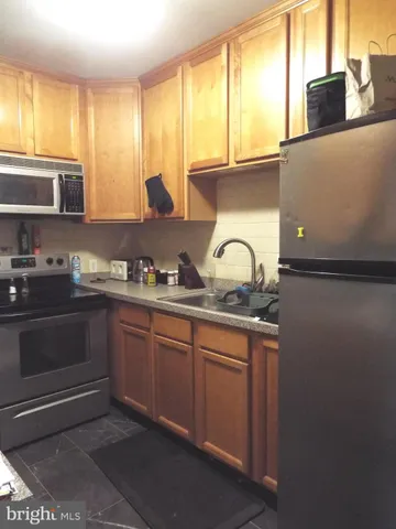 a kitchen with granite countertop a sink and a window