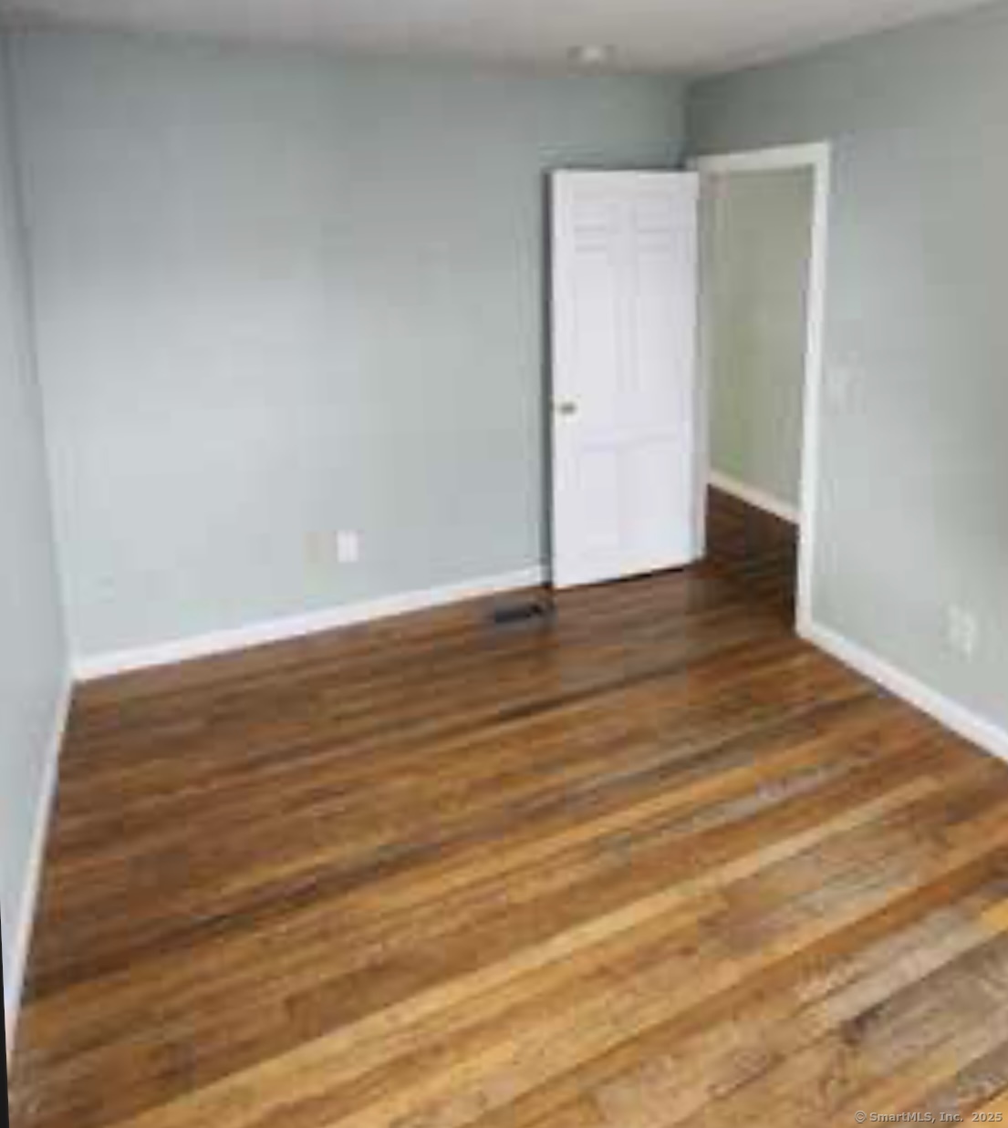 64 James Street Bridgeport, CT 06604 - Photo 2 of 8 a view of an empty room with wooden floor