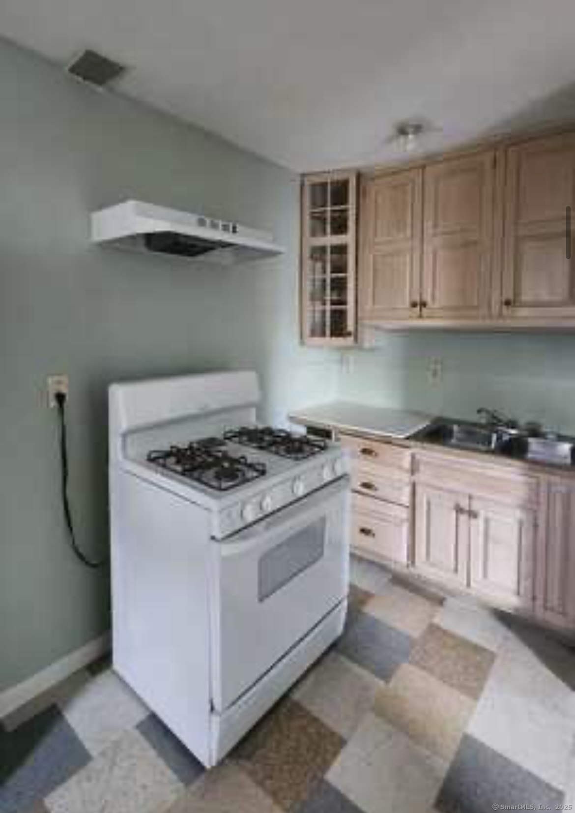 64 James Street Bridgeport, CT 06604 - Photo 5 of 8 a white stove top oven sitting inside of a kitchen