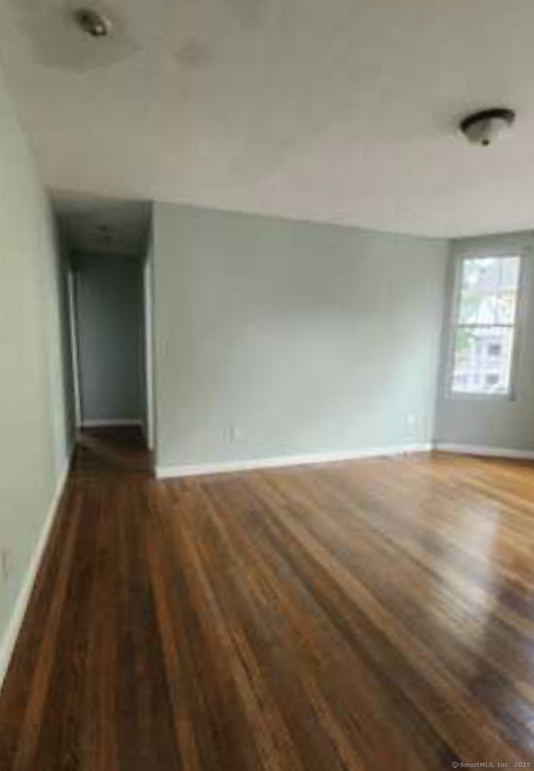 64 James Street Bridgeport, CT 06604 - Photo 8 of 8 an empty room with wooden floor and windows