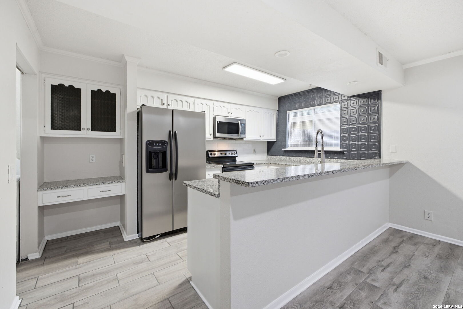 6106 Vance Jackson Road, Unit 15 San Antonio, TX 78230 - Photo 11 of 30 a kitchen with stainless steel appliances granite countertop a refrigerator and a stove top oven