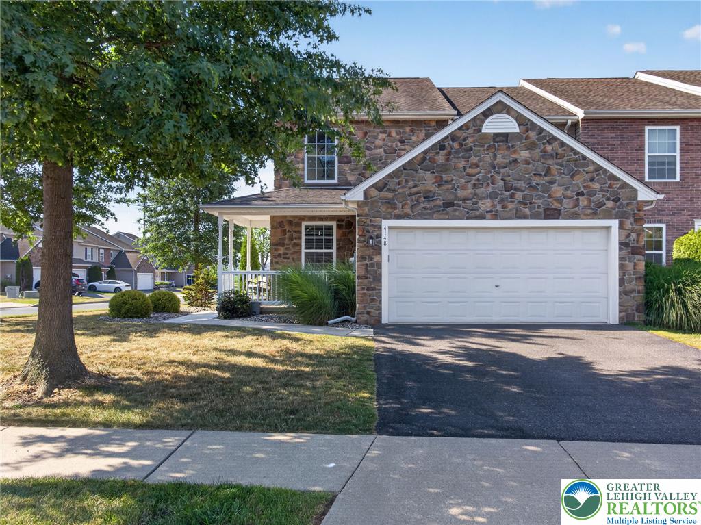 4148 Ross Road Bethlehem, PA 18020 - Photo 3 of 67 A welcoming stone facade with an inviting front porch and a paved driveway await.