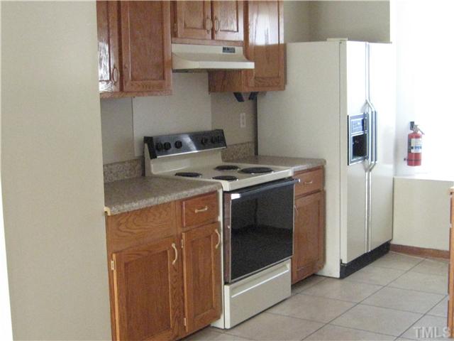 8147 McGuire Drive Raleigh, NC 27616 - Photo 2 of 6 a kitchen with stainless steel appliances granite countertop a stove a sink and a refrigerator