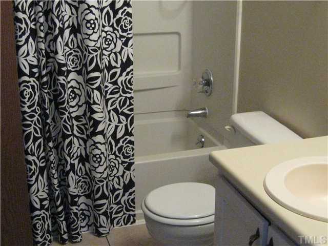 8147 McGuire Drive Raleigh, NC 27616 - Photo 3 of 6 a bathroom with a toilet and a bathtub
