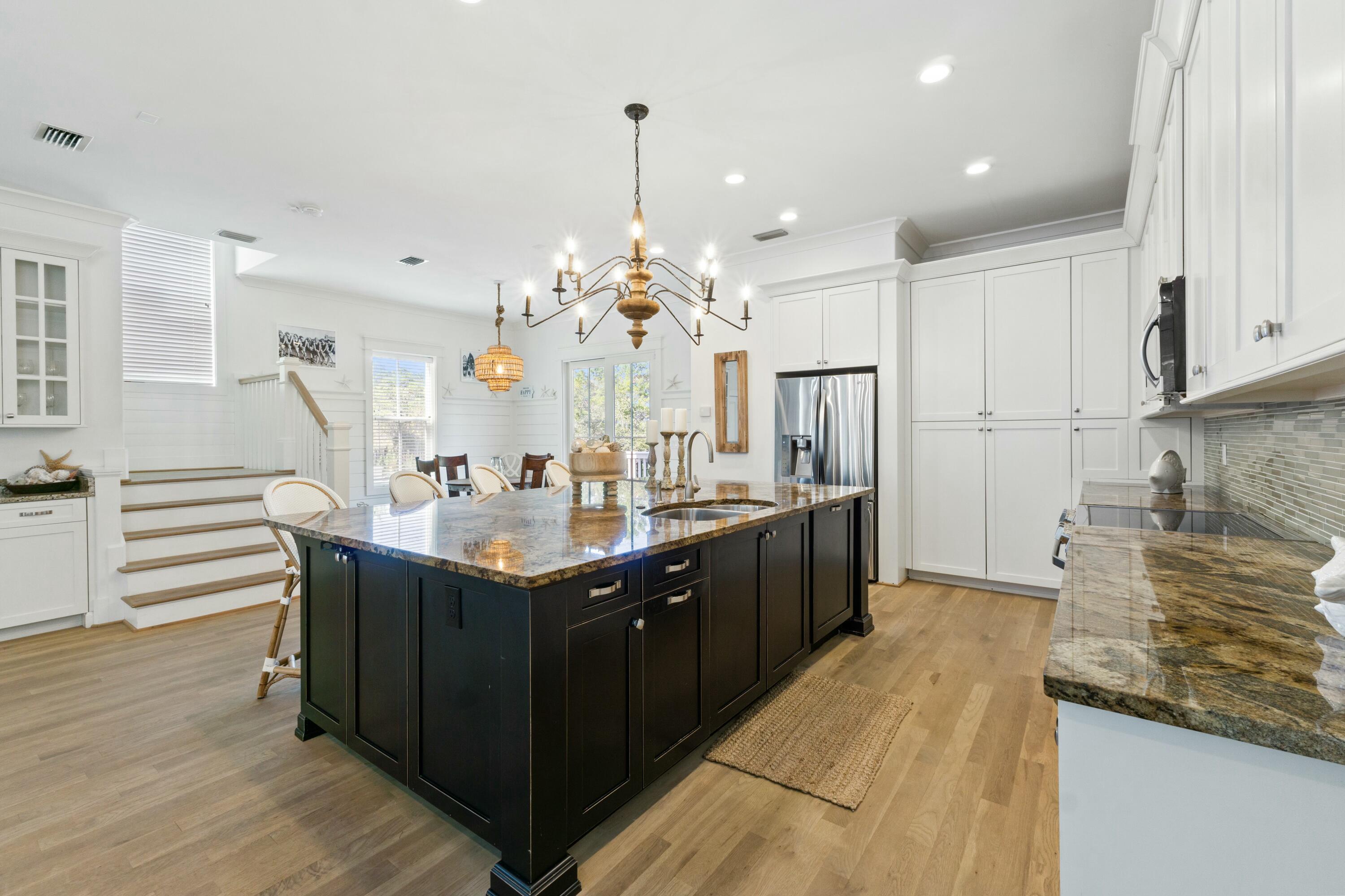125 Gulfview Circle Santa Rosa Beach, FL 32459 - Photo 11 of 57 a kitchen with stainless steel appliances granite countertop a sink a stove and a refrigerator