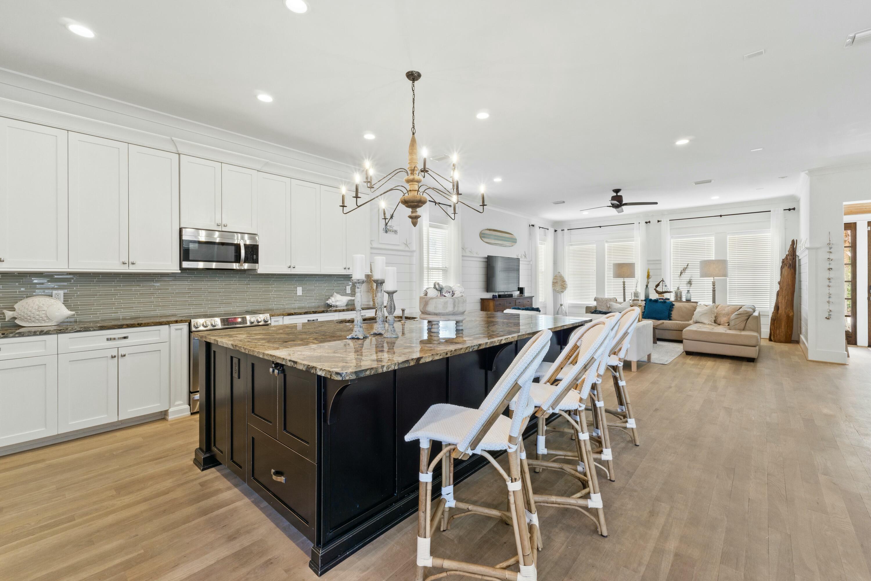 125 Gulfview Circle Santa Rosa Beach, FL 32459 - Photo 13 of 57 a open kitchen with stainless steel appliances granite countertop a stove and a white cabinets