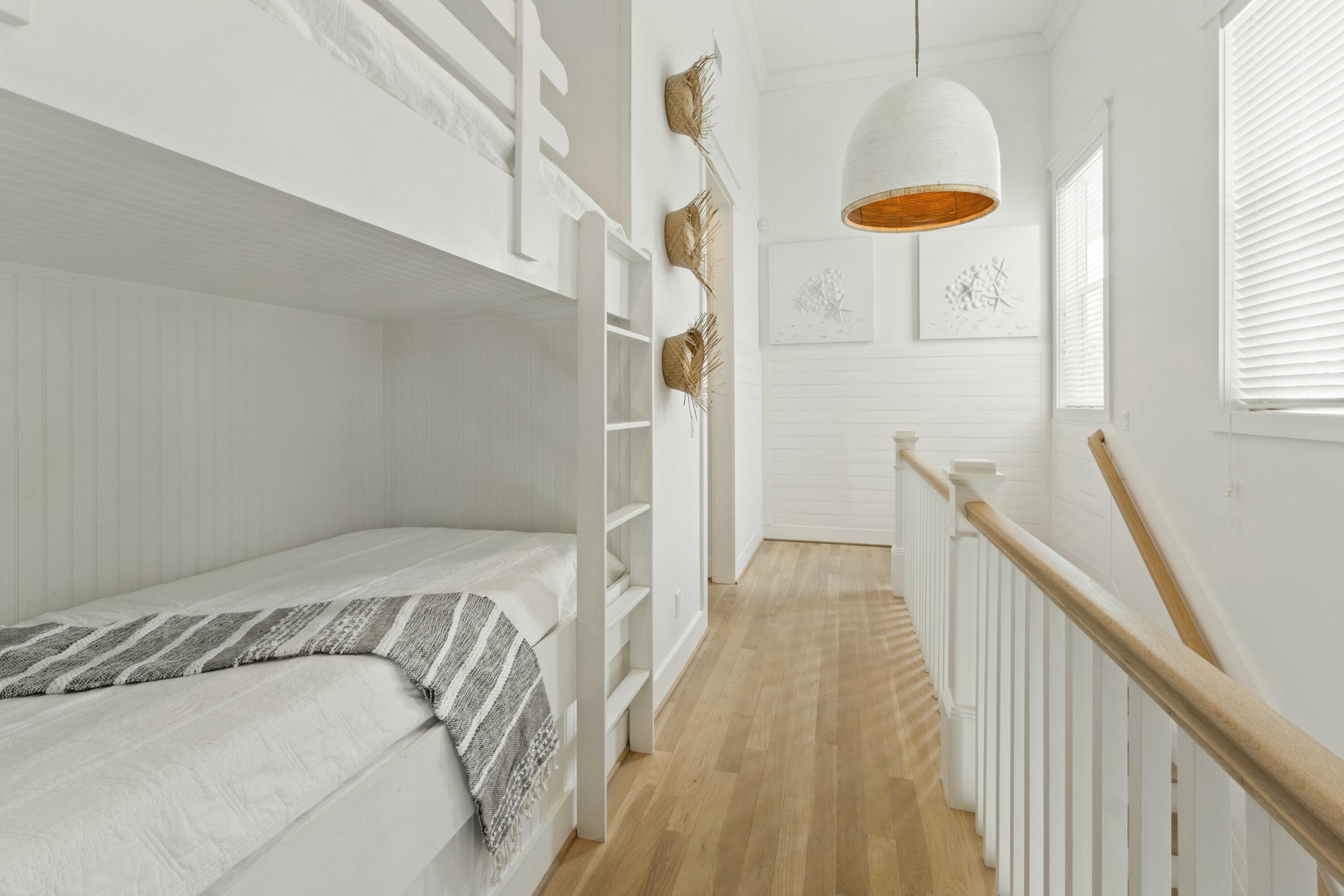 125 Gulfview Circle Santa Rosa Beach, FL 32459 - Photo 19 of 57 a view of a bedroom with wooden floor and staircase