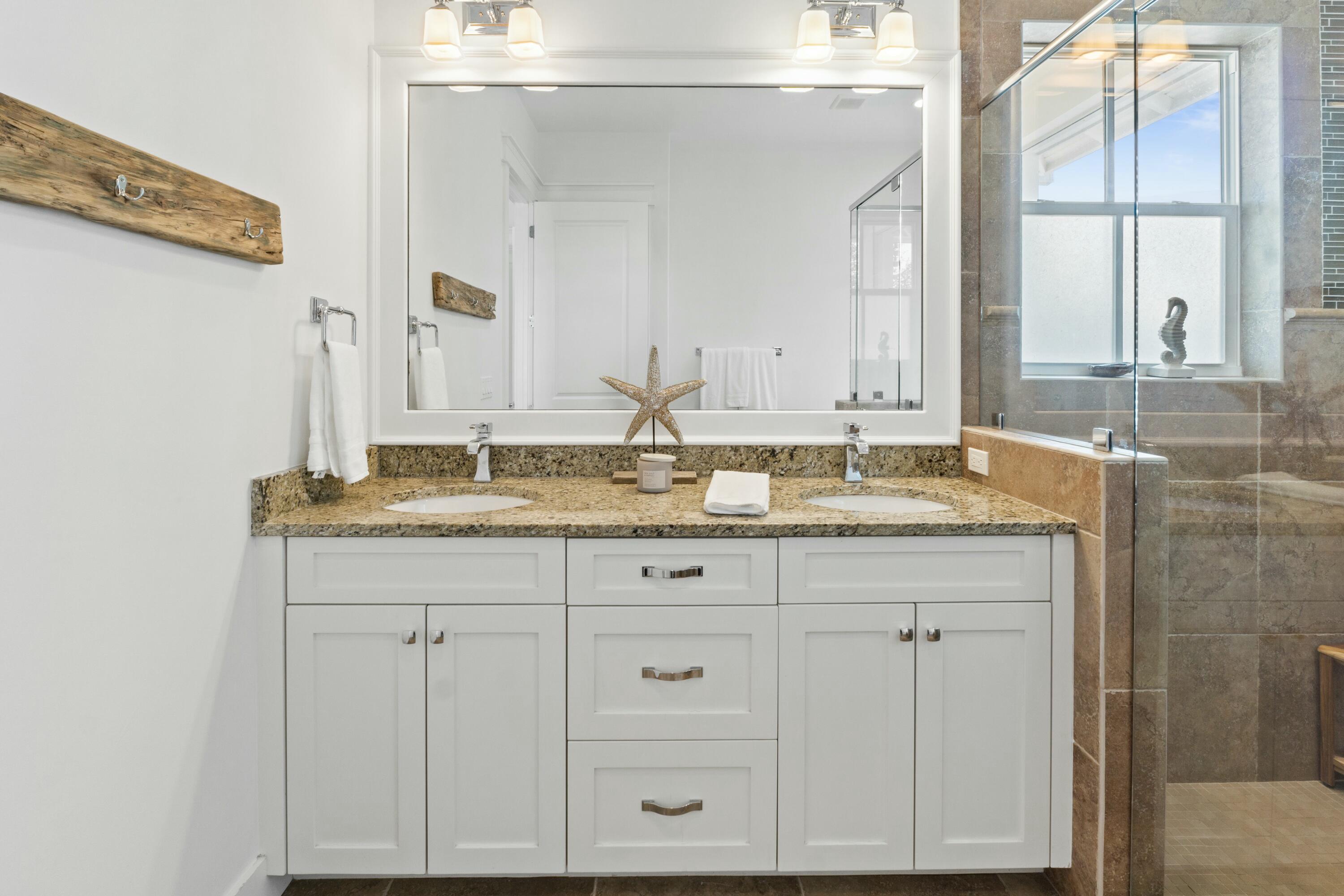 125 Gulfview Circle Santa Rosa Beach, FL 32459 - Photo 31 of 57 a bathroom with a granite countertop sink and a mirror