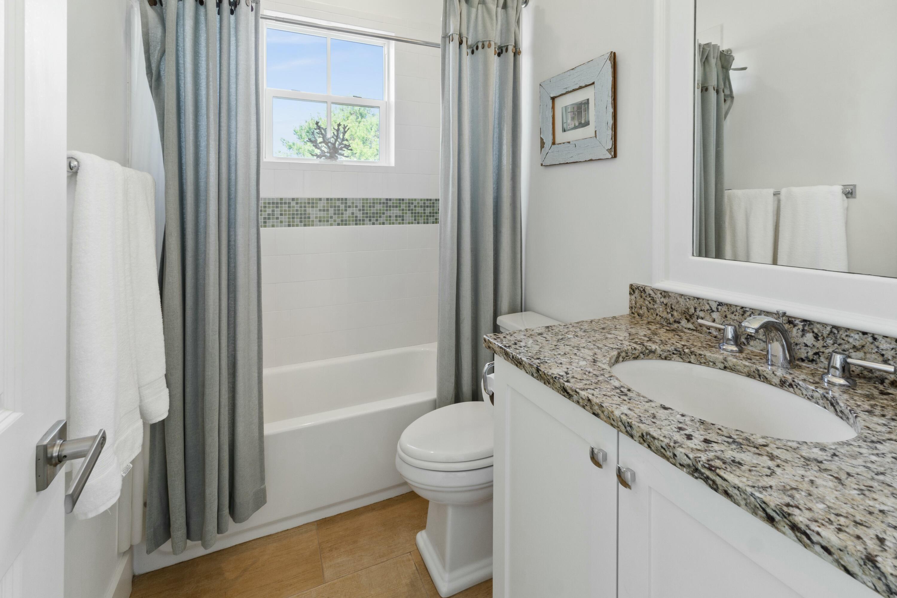 125 Gulfview Circle Santa Rosa Beach, FL 32459 - Photo 38 of 57 a bathroom with a granite countertop sink toilet and shower