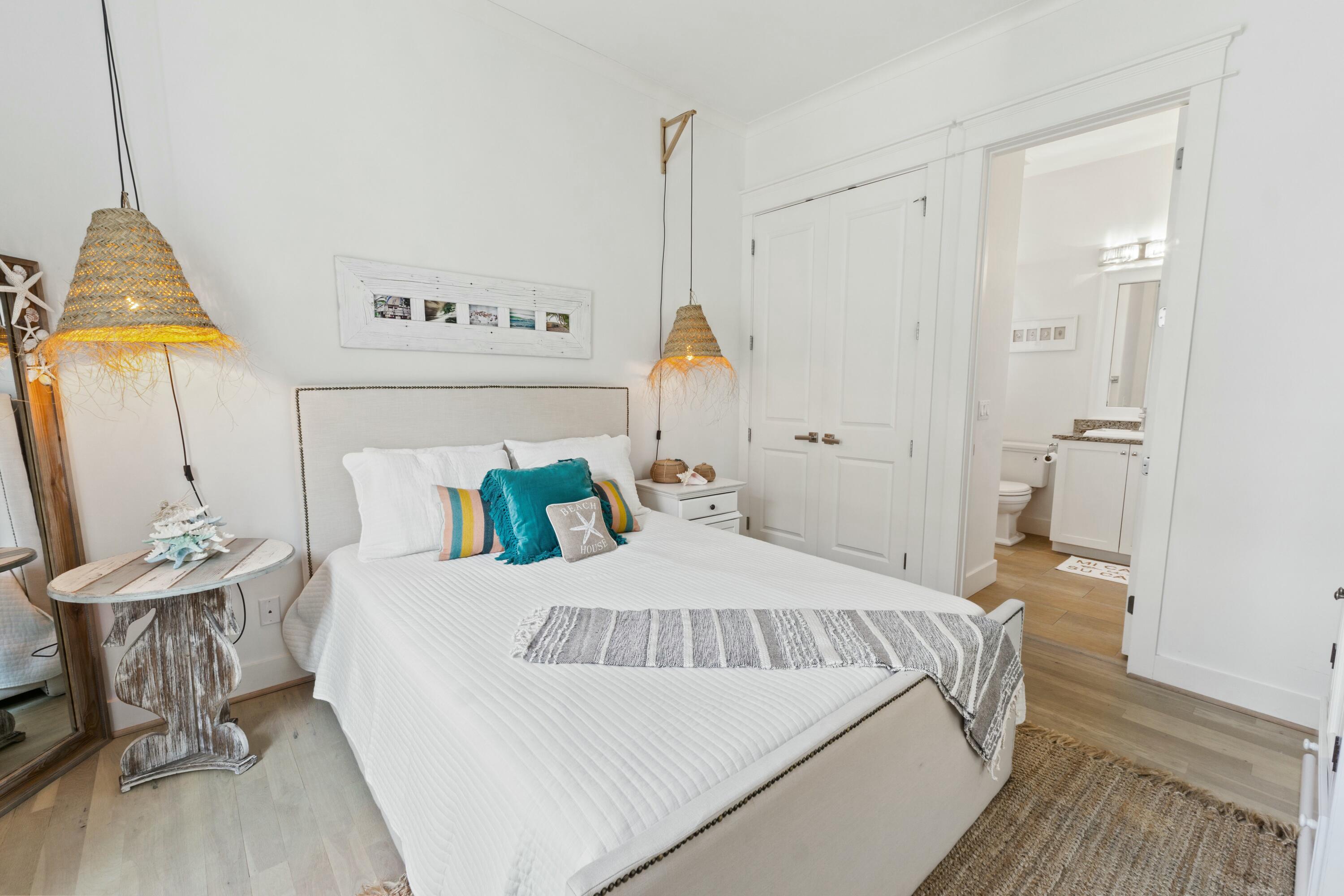 125 Gulfview Circle Santa Rosa Beach, FL 32459 - Photo 41 of 57 a bedroom with a bed a mirror and dresser