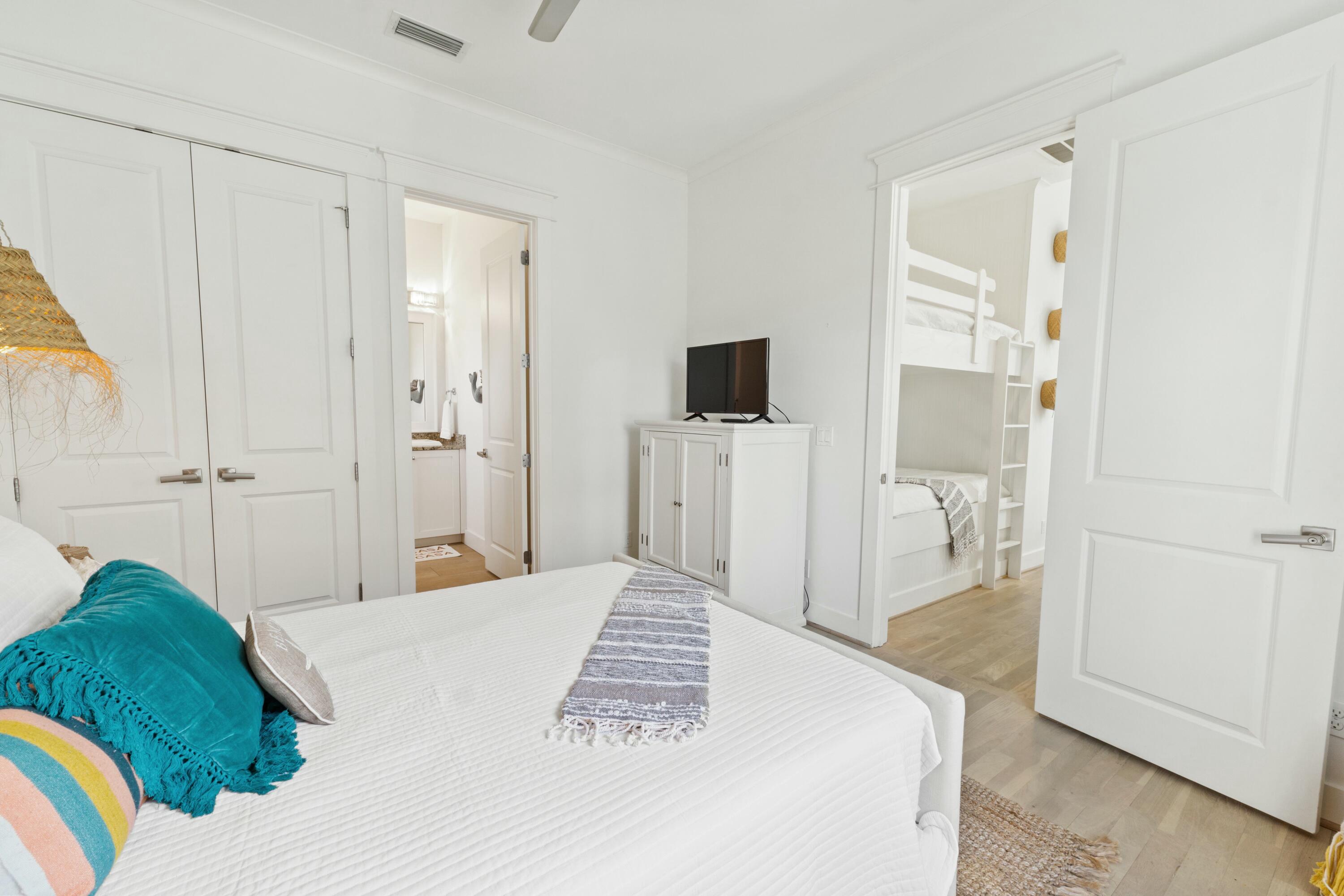 125 Gulfview Circle Santa Rosa Beach, FL 32459 - Photo 42 of 57 a bedroom with a bed and a mirror