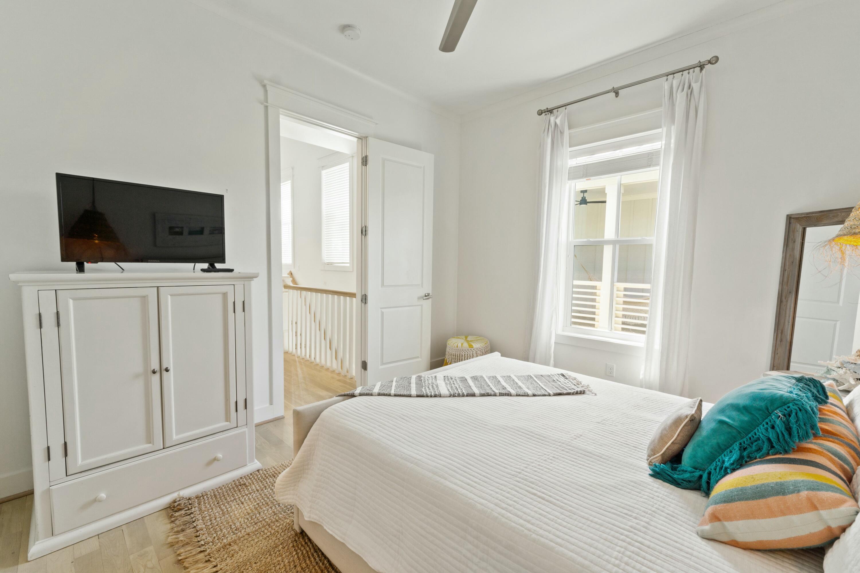 125 Gulfview Circle Santa Rosa Beach, FL 32459 - Photo 43 of 57 a bedroom with a bed a flat tv screen and a window