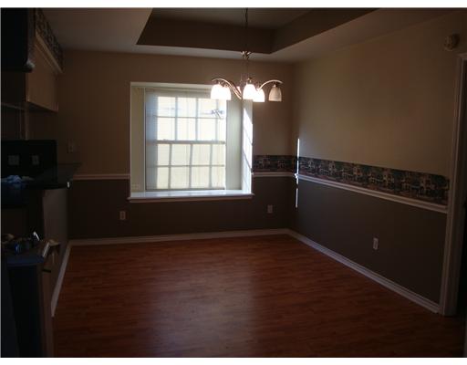 4246 Valley Circle Corpus Christi, TX 78413 - Photo 3 of 7 an empty room with wooden floor and windows