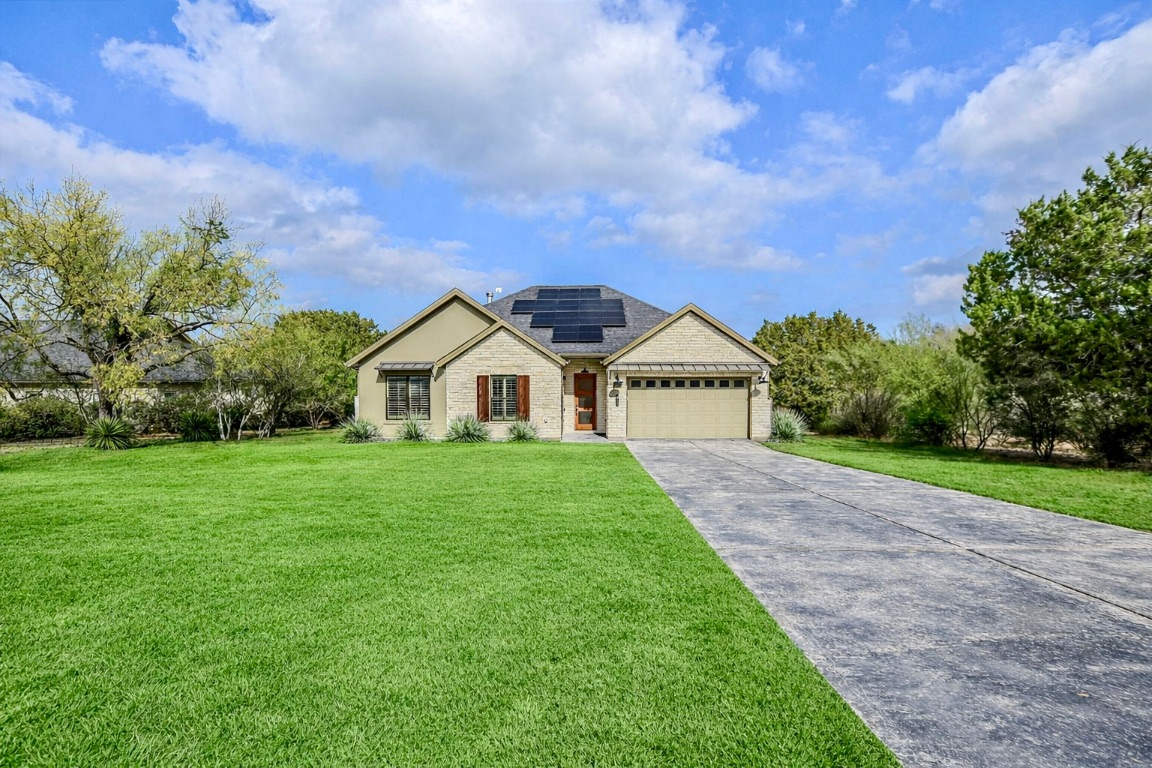 a view of a house with yard and a garden