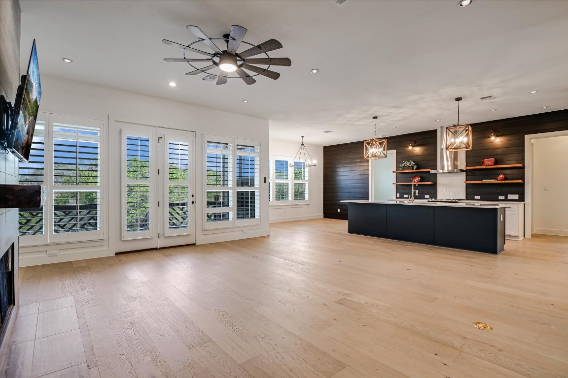 935 Wesley Ridge Drive Spicewood, TX 78669 - Photo 14 of 40 a view of an empty room with a window and wooden floor