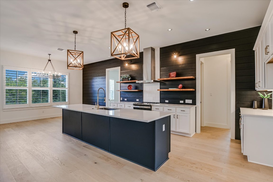 935 Wesley Ridge Drive Spicewood, TX 78669 - Photo 15 of 40 a kitchen with cabinets a counter space appliances and a ceiling fan