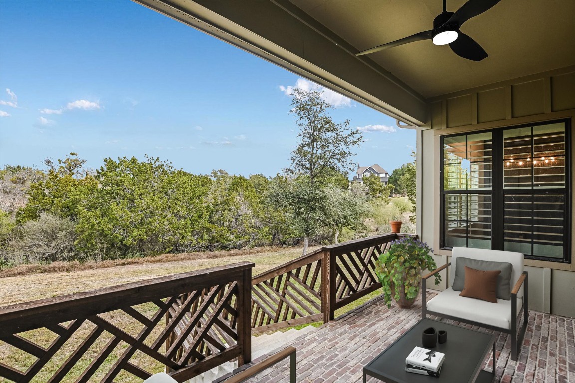 935 Wesley Ridge Drive Spicewood, TX 78669 - Photo 25 of 40 a balcony with wooden floor and outdoor seating