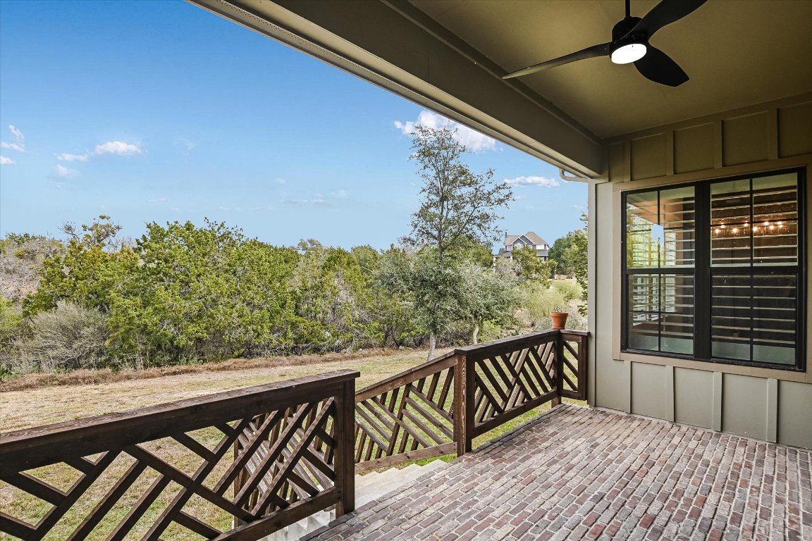 935 Wesley Ridge Drive Spicewood, TX 78669 - Photo 26 of 40 a balcony with wooden floor and fence