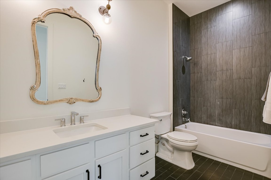 935 Wesley Ridge Drive Spicewood, TX 78669 - Photo 32 of 40 The guest bath feels fresh and functional, with a long vanity, plenty of counter space, and a tub-shower combination. Simple finishes and a neutral palette enhance the room.