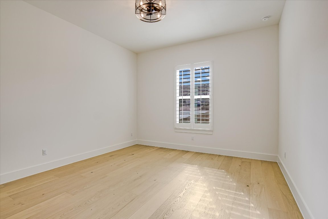 935 Wesley Ridge Drive Spicewood, TX 78669 - Photo 33 of 40 This additional secondary bedroom offers the same clean, simple feel found throughout the home and sits quietly within the guest wing. It’s a flexible space that can easily adapt as needs change.