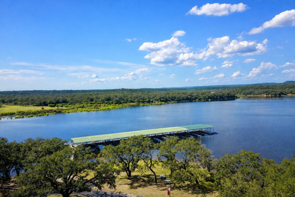 935 Wesley Ridge Drive Spicewood, TX 78669 - Photo 40 of 40 a view of a lake with a houses