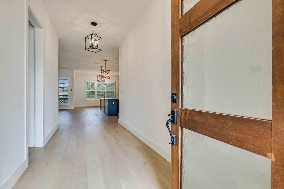 935 Wesley Ridge Drive Spicewood, TX 78669 - Photo 4 of 40 Stepping inside, the entry foyer draws you toward the main living, kitchen and dining areas.