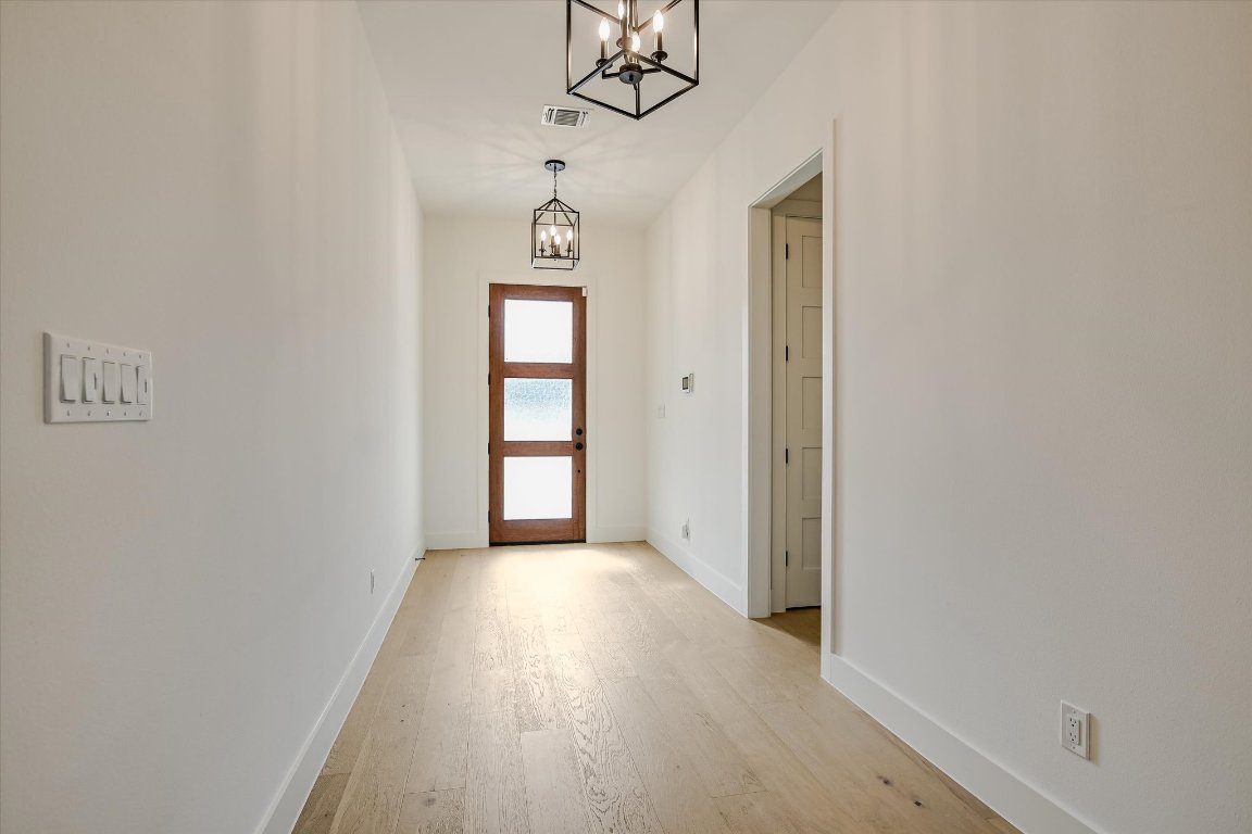 935 Wesley Ridge Drive Spicewood, TX 78669 - Photo 6 of 40 a view of a room with wooden floor and windows